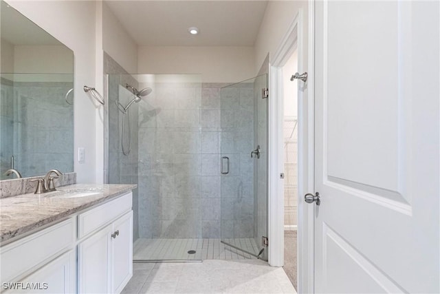 bathroom featuring an enclosed shower, vanity, and tile patterned floors