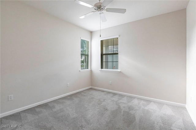 carpeted spare room with ceiling fan