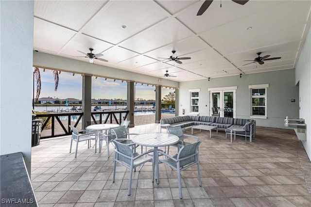 view of patio / terrace with a water view and an outdoor hangout area