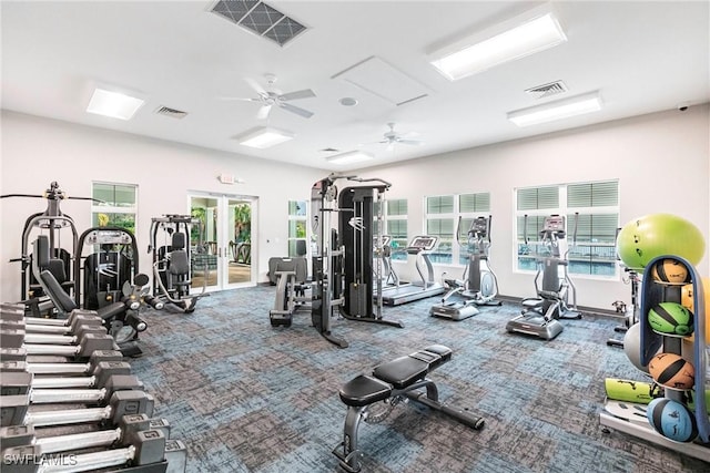 gym with carpet, a wealth of natural light, ceiling fan, and french doors