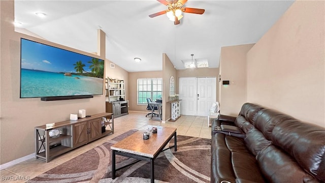 living room with ceiling fan, vaulted ceiling, and light tile patterned floors