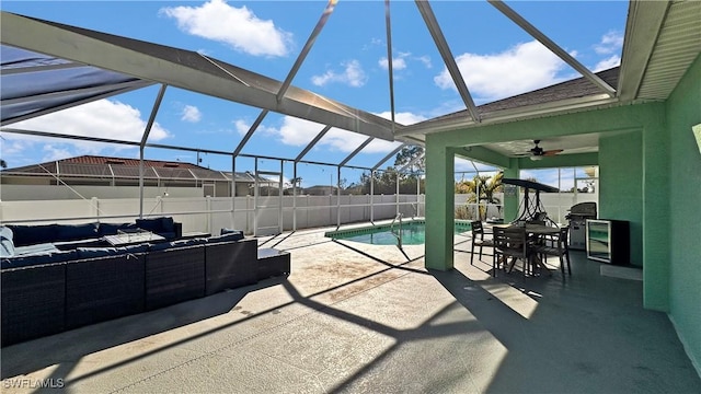 view of patio / terrace with a fenced in pool, an outdoor hangout area, ceiling fan, and glass enclosure