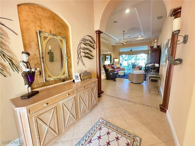 28880 Kiranicola Ct, Bonita Springs, FL 34135 - corridor featuring arched walkways, light tile patterned flooring, a tray ceiling, ornate columns, and baseboards