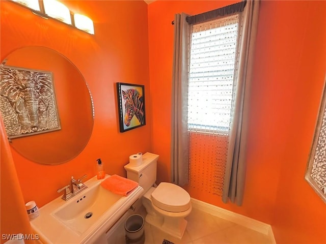 28880 Kiranicola Ct, Bonita Springs, FL 34135 - bathroom featuring a sink, toilet, tile patterned flooring, and baseboards