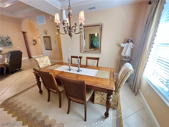 28880 Kiranicola Ct, Bonita Springs, FL 34135 - dining space featuring light tile patterned flooring, a chandelier, healthy amount of natural light, arched walkways, and crown molding