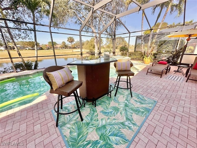 view of patio with a lanai, a water view, and an outdoor pool