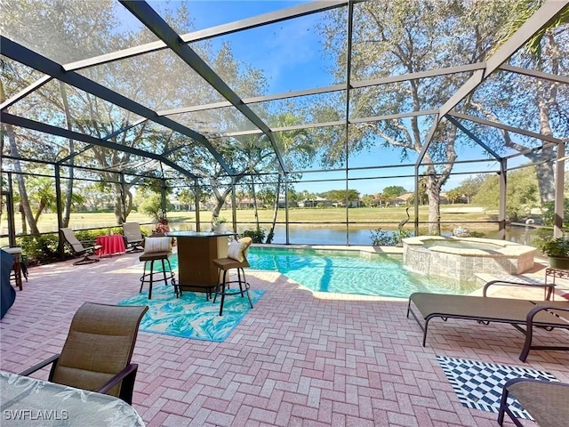 view of pool featuring a pool with connected hot tub, a patio area, a water view, and a lanai