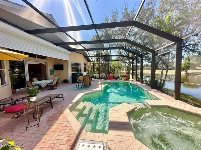 view of pool featuring a pool with connected hot tub, glass enclosure, and a patio