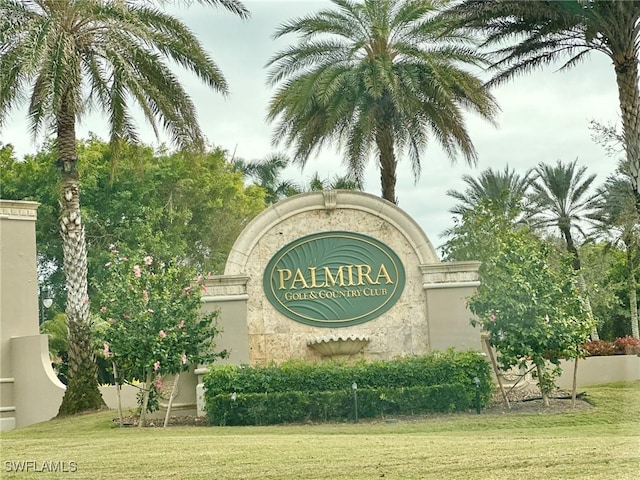 community / neighborhood sign with a yard