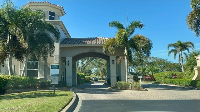 exterior space featuring a gated entry and curbs