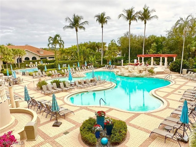 pool with a patio and a pergola