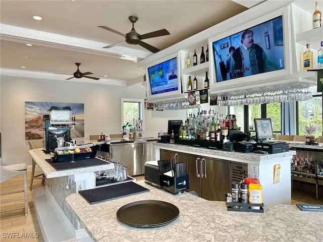 interior space featuring light wood finished floors, a bar, a wealth of natural light, and recessed lighting