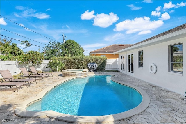 view of swimming pool with a patio area, french doors, and an in ground hot tub