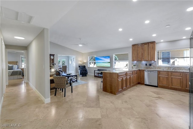 kitchen with lofted ceiling, sink, dishwasher, tasteful backsplash, and kitchen peninsula