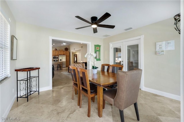 dining area featuring ceiling fan and french doors