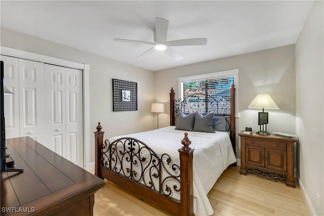 bedroom with ceiling fan, a closet, and light hardwood / wood-style flooring