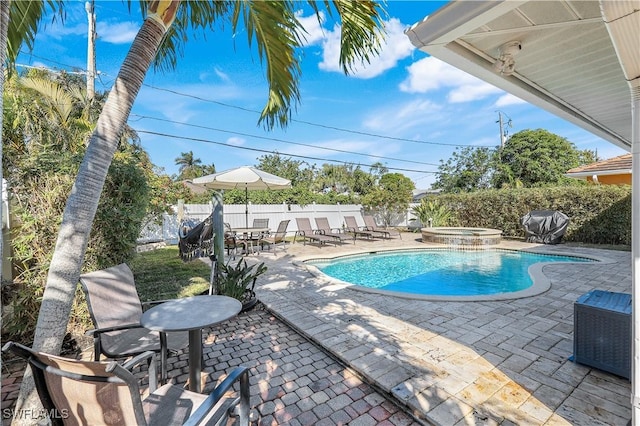 view of swimming pool with an in ground hot tub and a patio