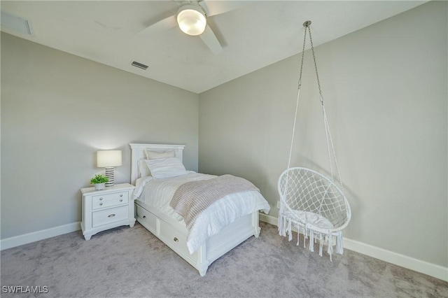 bedroom featuring baseboards, a ceiling fan, visible vents, and light colored carpet