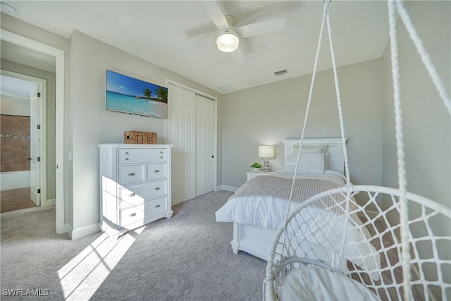 bedroom featuring ceiling fan, light colored carpet, and a closet