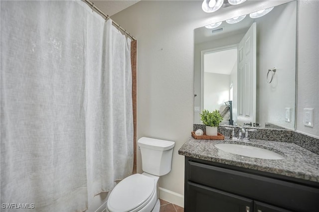 bathroom featuring vanity, toilet, and curtained shower