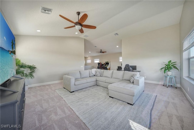 living room featuring lofted ceiling, light colored carpet, and ceiling fan