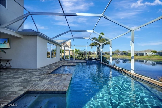 view of pool featuring a water view, glass enclosure, a pool with connected hot tub, and a patio