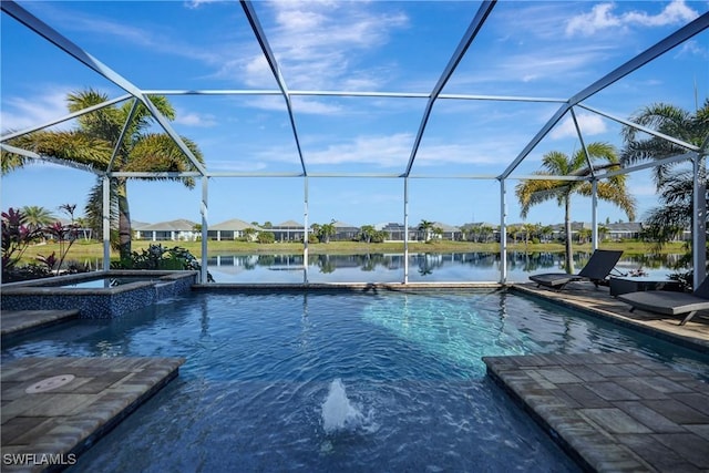 view of pool featuring glass enclosure, a water view, and a pool with connected hot tub