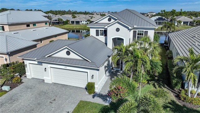 exterior space with a water view, a standing seam roof, and metal roof