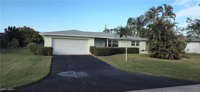 ranch-style home featuring a garage and a front lawn