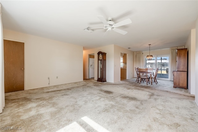 unfurnished living room with ceiling fan and light carpet