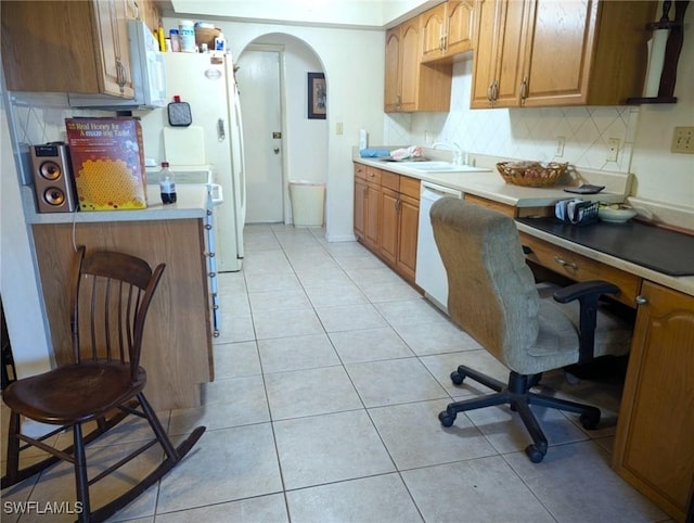 kitchen with sink, light tile patterned floors, white dishwasher, and decorative backsplash