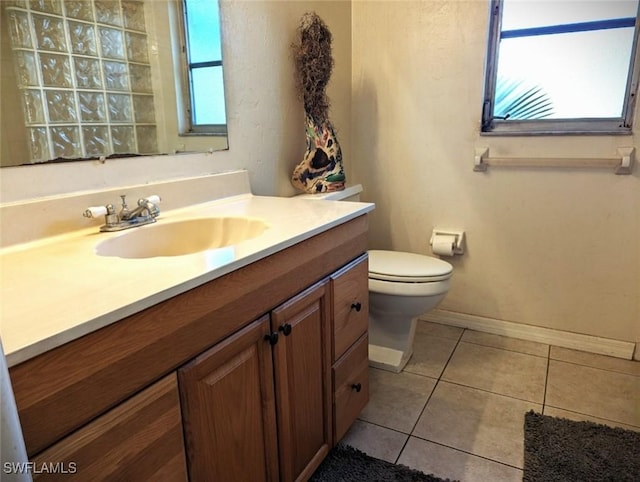 bathroom featuring tile patterned flooring, vanity, and toilet