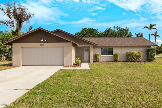 ranch-style house with a garage and a front lawn