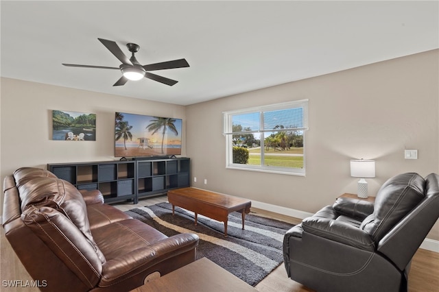 living room featuring ceiling fan and light hardwood / wood-style flooring