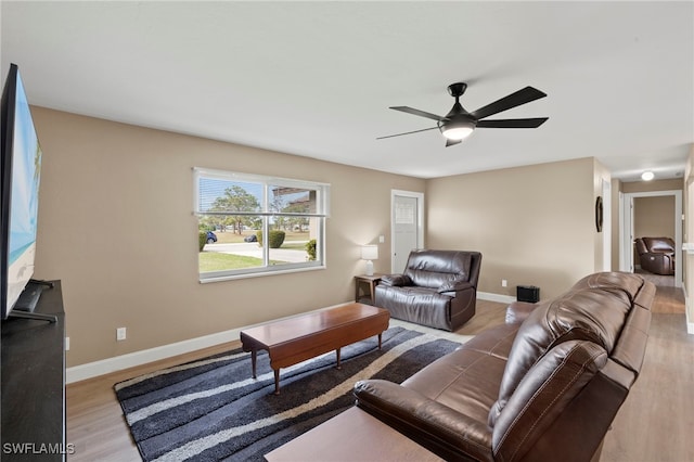 living room with ceiling fan and light hardwood / wood-style flooring