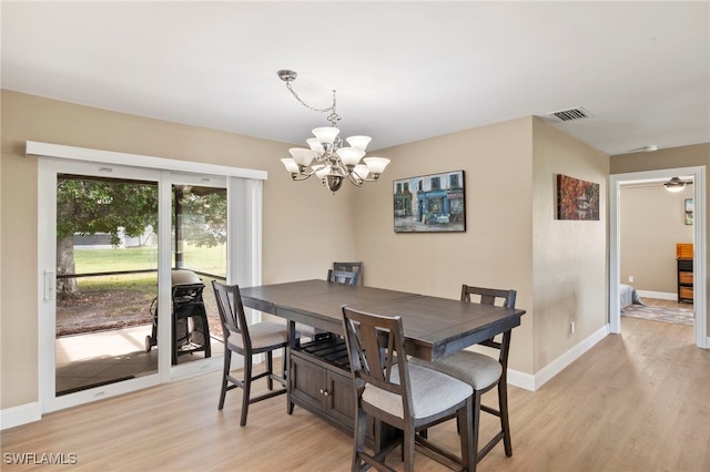 dining room featuring light hardwood / wood-style floors and a notable chandelier