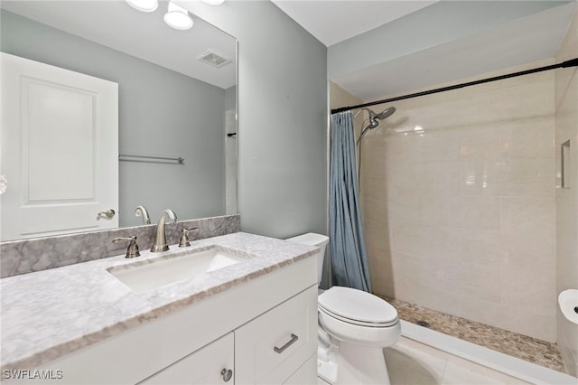 bathroom with vanity, curtained shower, tile patterned floors, and toilet