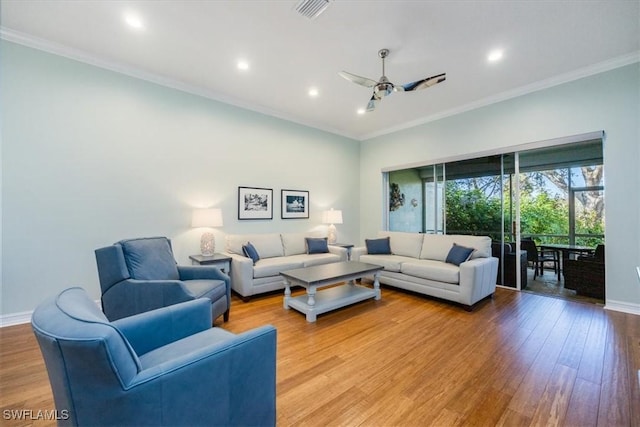 living room featuring crown molding, light hardwood / wood-style flooring, and ceiling fan