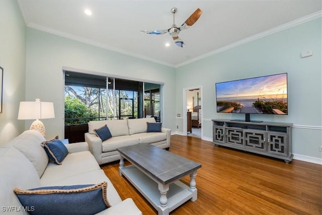 living room with hardwood / wood-style flooring, ceiling fan, and ornamental molding