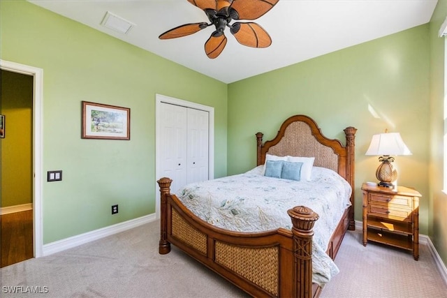 carpeted bedroom featuring ceiling fan and a closet