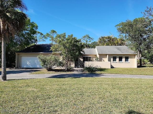 ranch-style home with a garage and a front yard