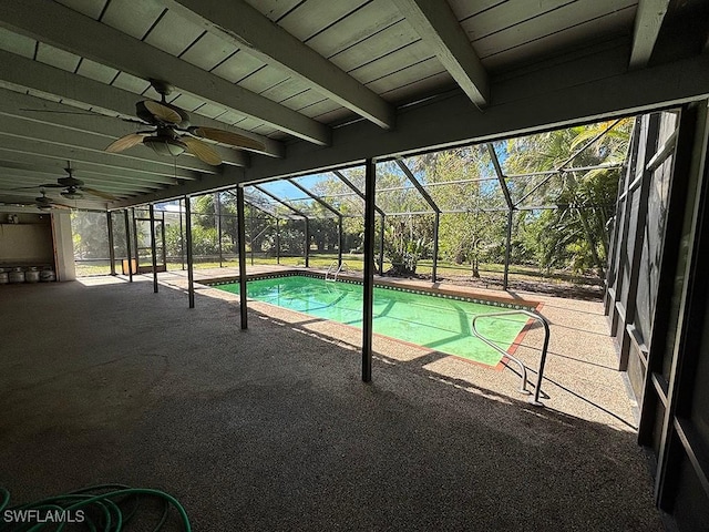 view of pool with a patio, ceiling fan, and glass enclosure