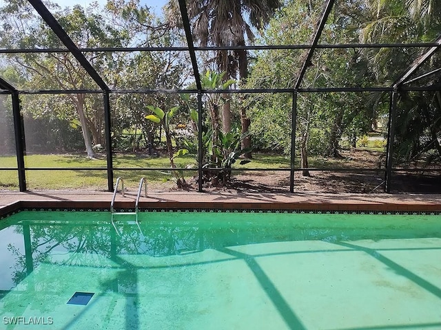 view of pool featuring glass enclosure