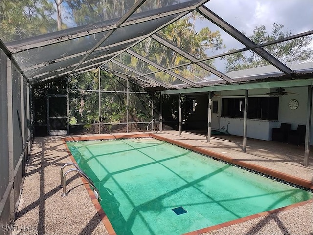 view of pool with ceiling fan, a lanai, and a patio