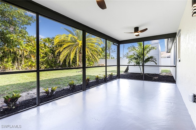 unfurnished sunroom with ceiling fan