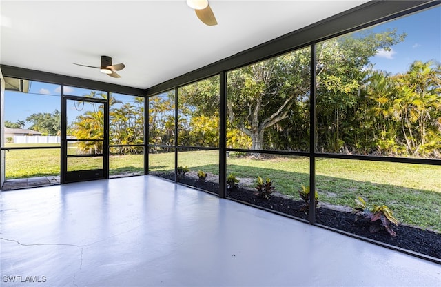 unfurnished sunroom featuring ceiling fan