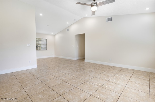 tiled empty room featuring lofted ceiling and ceiling fan