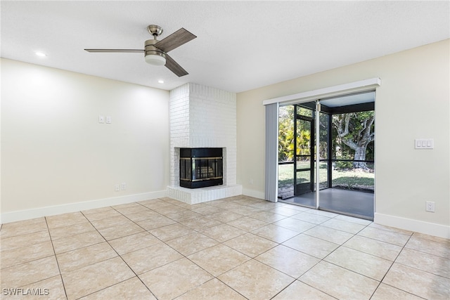 unfurnished living room featuring light tile patterned floors, ceiling fan, and a fireplace