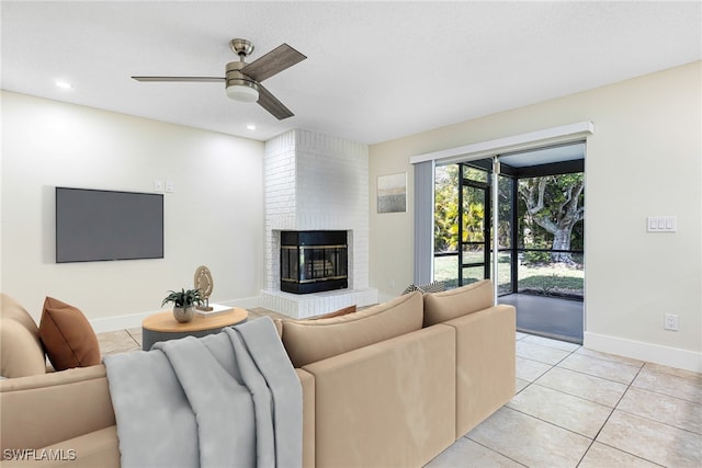 tiled living room with ceiling fan and a fireplace