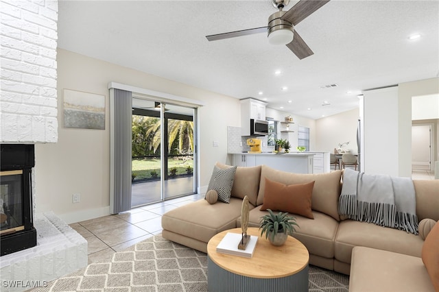 living room with ceiling fan and light tile patterned floors